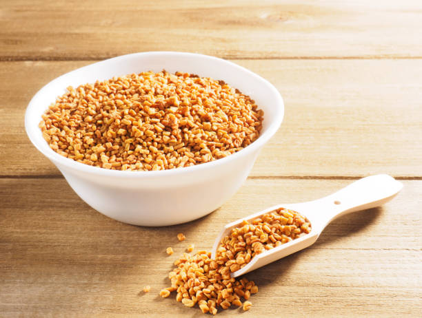istock Fenugreek (Trigonella) in a ceramic white cup with scoop on a wooden background 1167505834