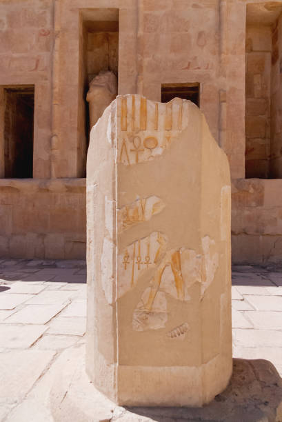 Mortuary temple of Hatshepsut in Deir el-Bahari. Ancient wall with the engraved Egyptian hieroglyphs. Deir el-Bahari, Egypt. Mortuary temple of Hatshepsut in Deir el-Bahari. Ancient wall with the engraved Egyptian hieroglyphs. Deir el-Bahari, Egypt. el bahari stock pictures, royalty-free photos & images