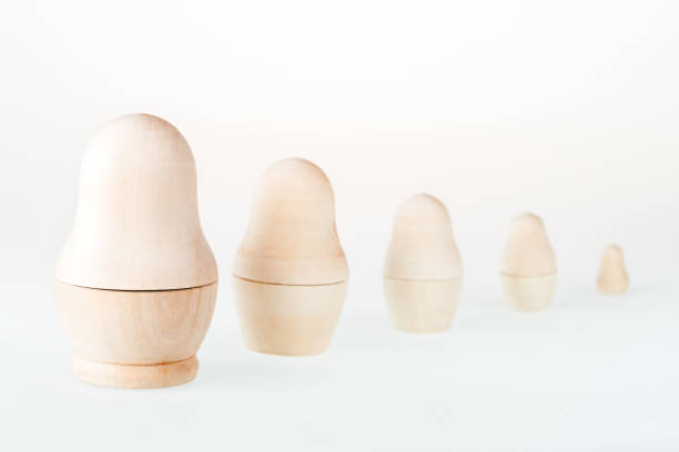 istock Clear wooden nesting dolls. Russian traditional toy, named matryoshka, on white background. Copy space. 1167506607