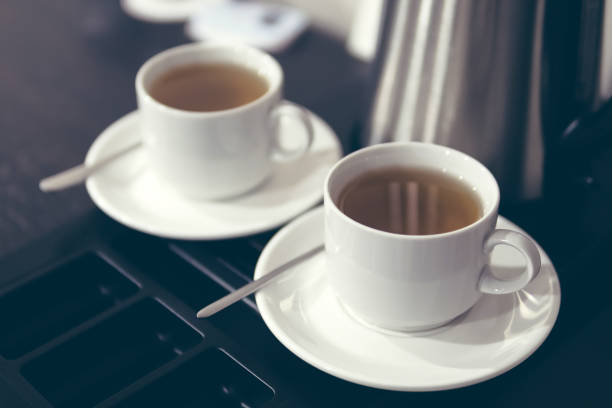 istock pair of white ceramic cups with tea 1167507008