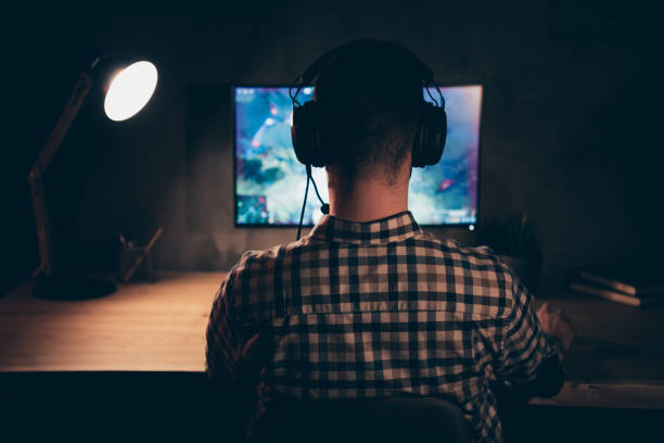 istock Close up back rear behind view photo he him his guy play videogame battle challenge participation talk teammates headset microphone wear casual plaid checkered shirt internet table house indoors 1167509509