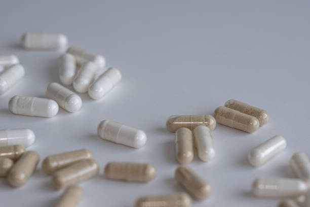 istock Piles of pills and capsule on white background. Selective focus 1167509619