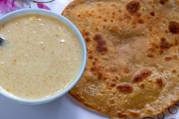 istock Egg Paratha with Dalia or Daliya, Cereal Food Know as Bulgur Cooked in Milk Served with Egg Stuffed Paratha or Indian Stuffed Bread with Egg or Fried Flatbread, Selective focus. 1167511669