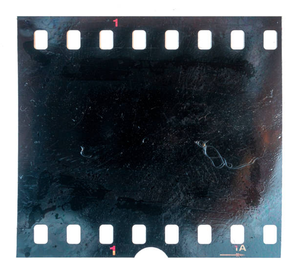 burned or burnt 35mm filmstrip or film material on white background, exposed and black film stock photo