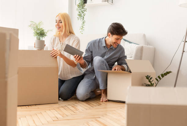 istock Gladful Couple Unpacking Boxes After Moving Into New Apartment 1167514038