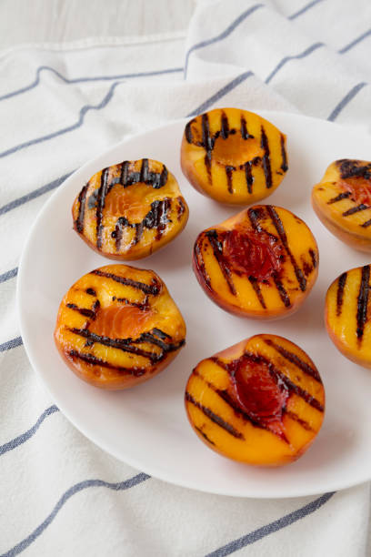 istock Homemade grilled peaches on a white plate, low angle view. Close-up. 1167514287