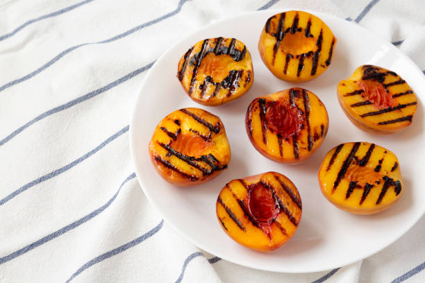 istock Homemade grilled peaches on a white plate, low angle view. Copy space. 1167515363