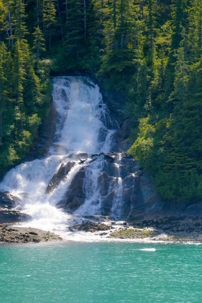 istock Beautiful waterfall flowing in full flood down into the ocean. 1167519744