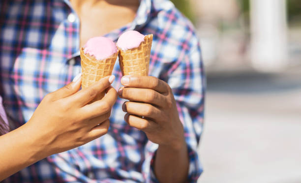 istock Young couple eating ice cream cones together 1167521085