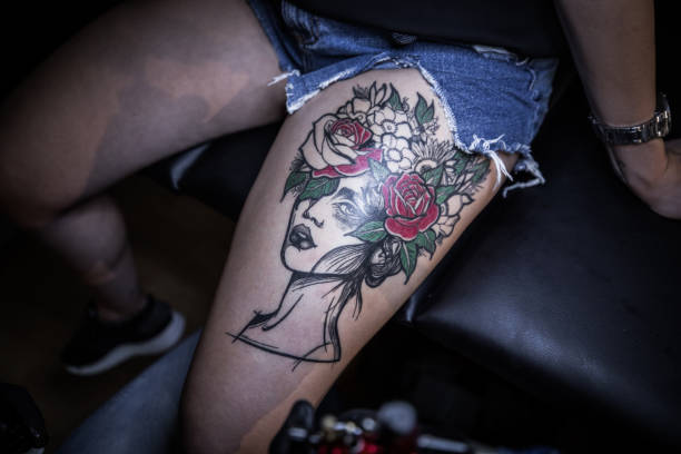 istock Tattoo artist making tattoo on customer's leg 1167521367