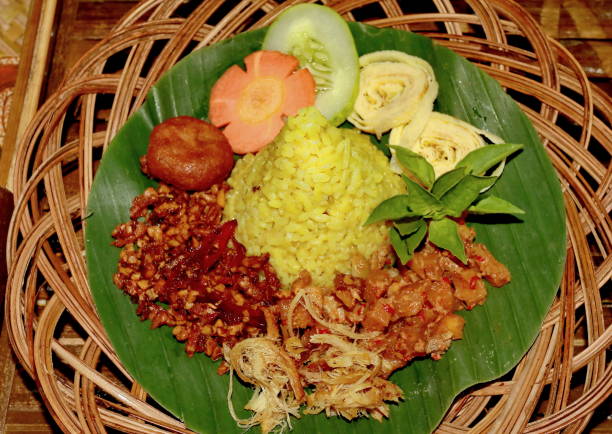 istock Nasi Kuning. Javanese turmeric rice with assorted side dishes 1167522865