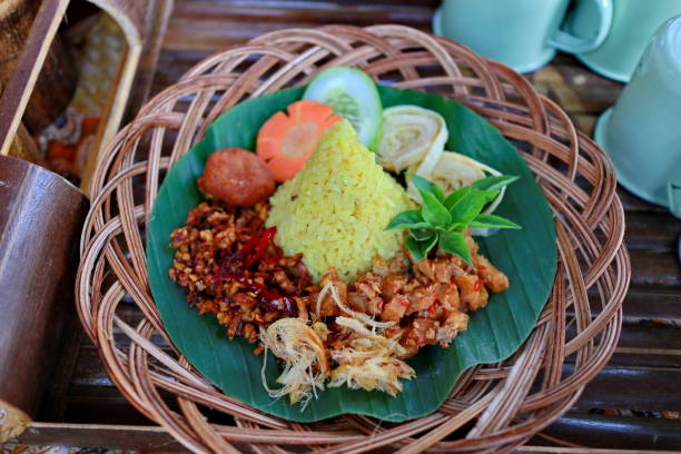 istock Nasi Kuning. Javanese turmeric rice with assorted side dishes 1167522954
