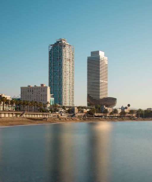 Reflection of two buildings on a beach in Barcelona (La Barceloneta).