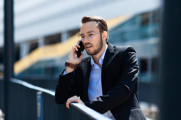 istock Bearded young man talking on a cell phone outdoors 1167525711