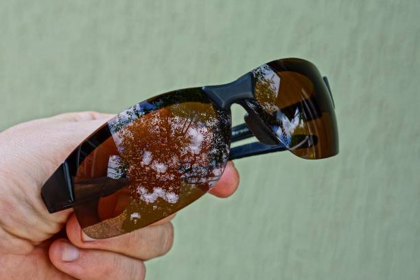 istock hand holds one brown sunglasses 1167527190