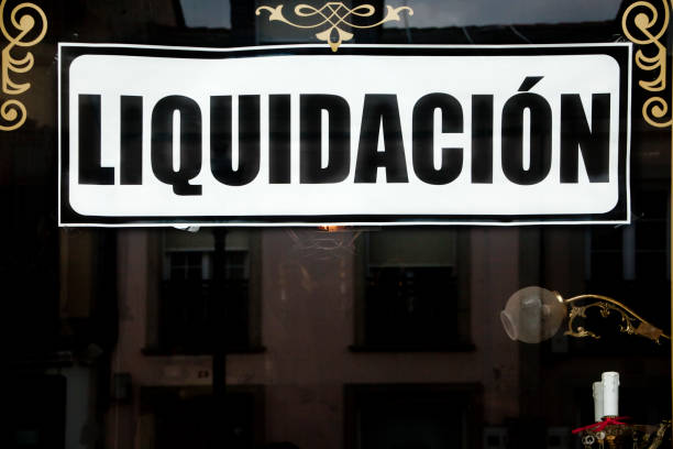 istock Liquidation, closedown sales sign on window store. 1167527341