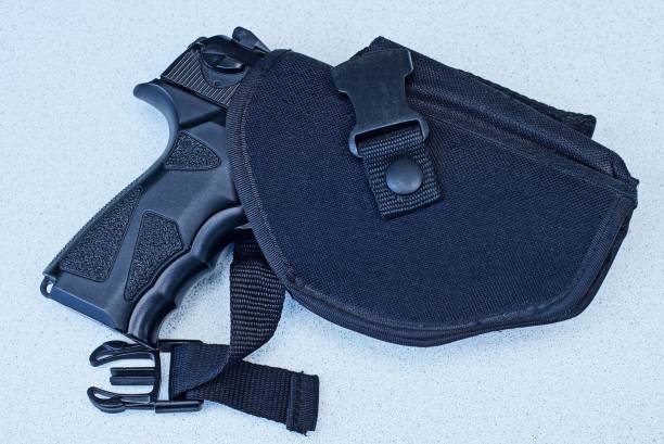 istock big black gun in a holster lies on a gray table 1167527449