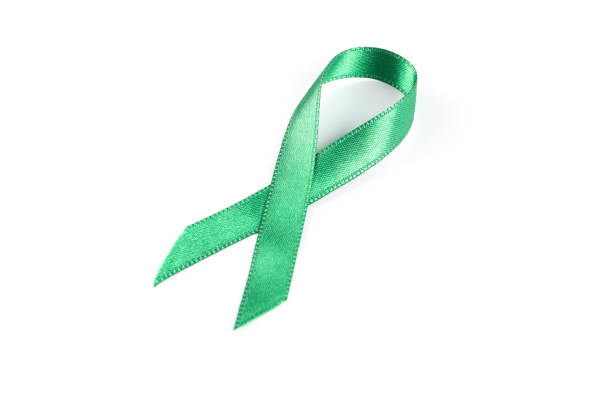 istock Green awareness ribbon isolated on white background 1167527488