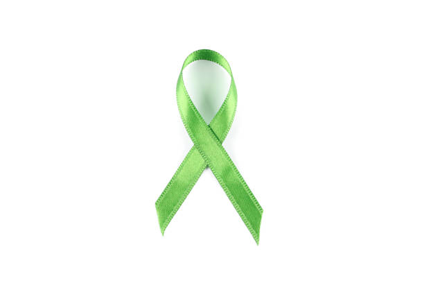 istock Green awareness ribbon isolated on white background 1167528674
