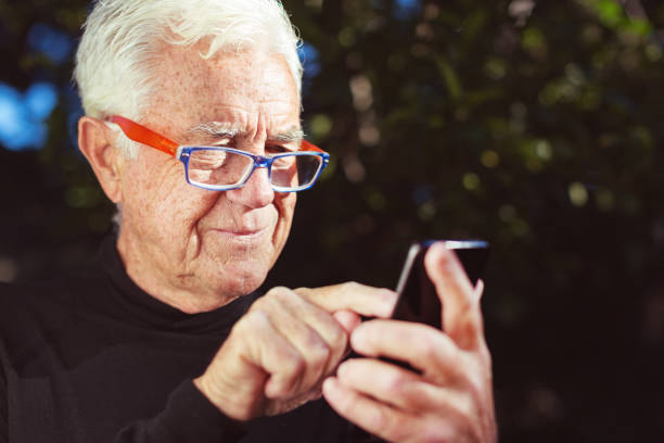 istock Smiling senior man sending text message on smart phone 1167528906