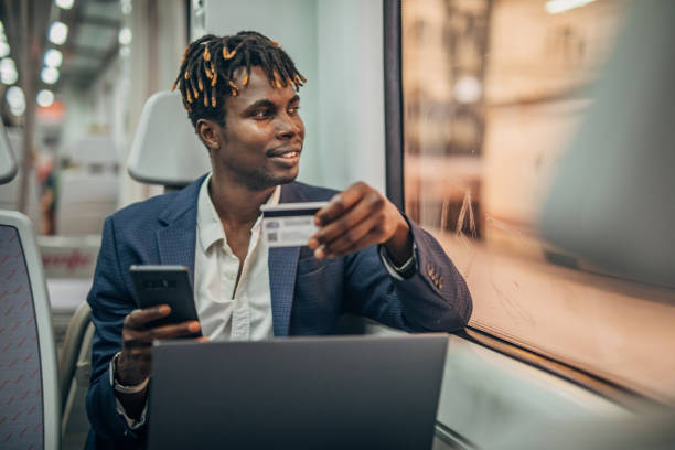 istock Young businessman with credit card in subway train 1167530327