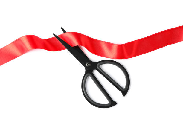 istock Red ribbon and scissors isolated on white background. Gift concept 1167530541