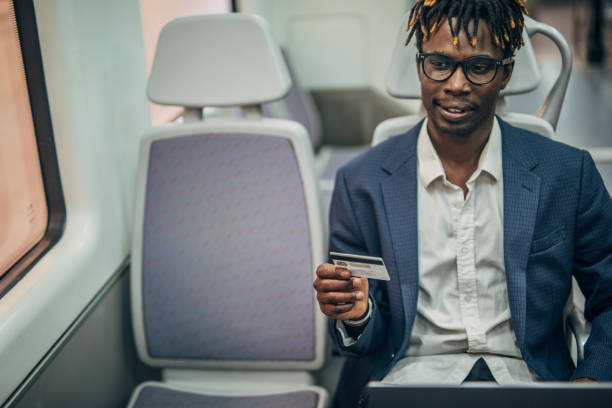 istock Black gentleman with credit card in subway train 1167531515