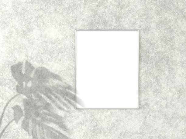 istock 4x5 vertical Chrome frame for photo or picture mockup on concrete background with shadow of monstera leaves. 3D rendering. 1167531575