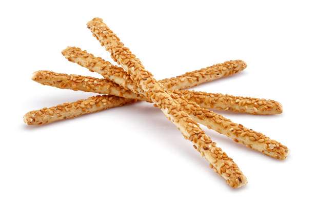 Sesame stick crackers or grissini isolated on white background