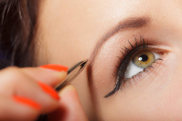 istock Girl tweezing eyebrows closeup 1167532292