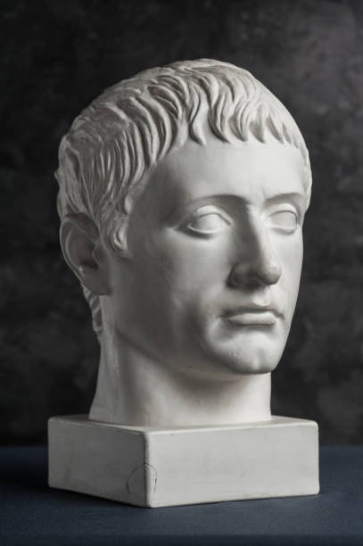 istock Gypsum copy of ancient statue Germanicus head on dark textured background. Plaster sculpture man face. 1167534968