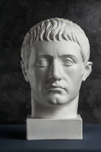istock Gypsum copy of ancient statue Germanicus head on dark textured background. Plaster sculpture man face. 1167534980