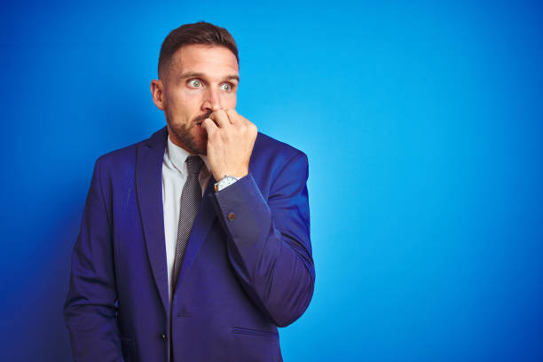 istock Young handsome business man over blue isolated background looking stressed and nervous with hands on mouth biting nails. Anxiety problem. 1167536433