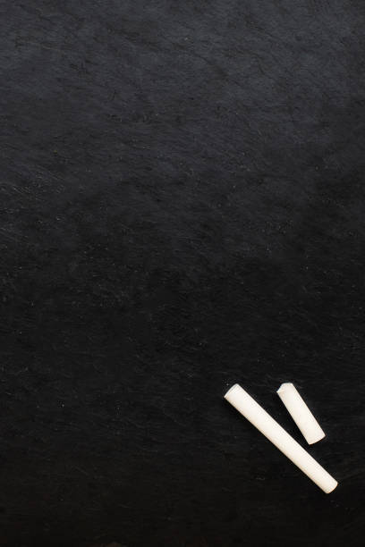 istock Back to school background with copy space and chalk pieces on Black old empty chalkboard.  Flat lay 