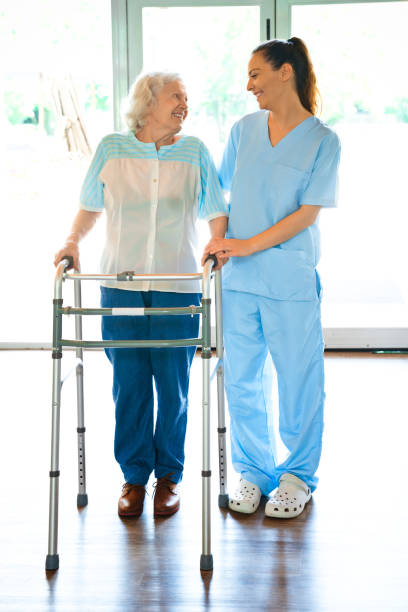 istock Nurse assisting senior woman with mobility walker 1167539704