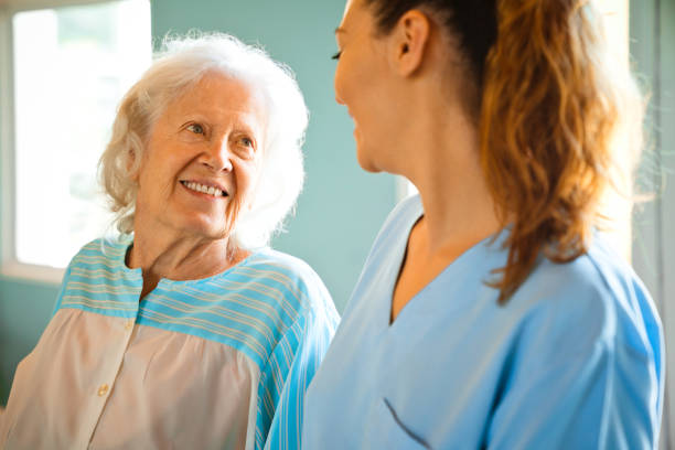 istock Smiling elderly woman looking at female nurse 1167540619