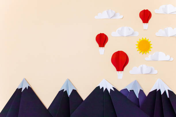 istock Origami mountains with hot air balloons, 3d clouds and sun. Creative composition for banner/landing page/background 1167540765