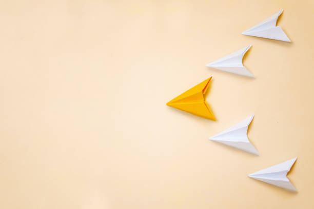 istock Leadership concept banner with origami paper planes and copy space on left side. Orange plane leading other. 1167540822