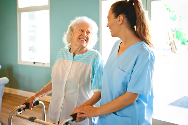 istock Smiling nurse assisting woman with mobility walker 1167540880