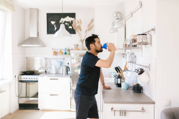 istock Asian man drinks protein shake after workout at home 1167541037
