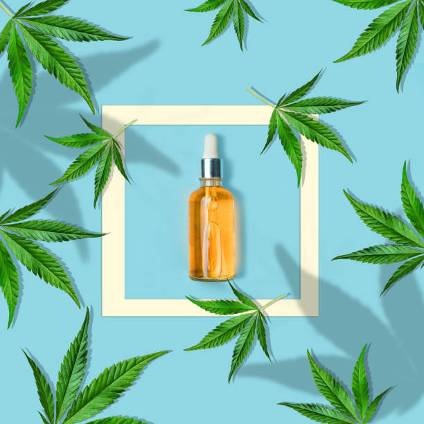 Composition of cannabis leaves on a light blue background with a bottle CBD OIL. Minimal cannabidiol concept. Flat lay Composition of cannabis leaves on a light yellow background with ribbon copy save. Minimal CBD OIL concept. Flat lay glass medicine blue bottle stock pictures, royalty-free photos & images