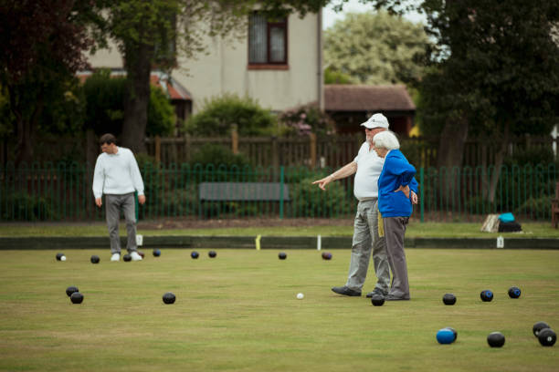 istock Teaching Senior Friend How to Lawn Bowl 1167544365