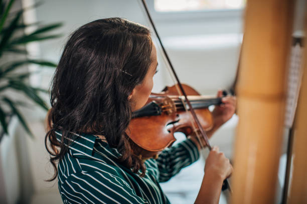 istock Woman violinist practicing at home 1167544636