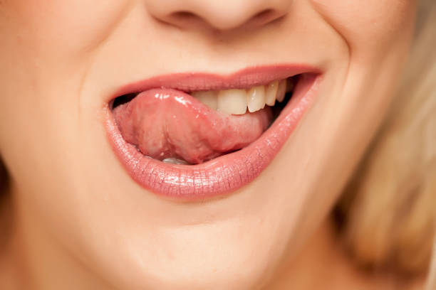 istock woman licking her lips with her tongue 1167548752