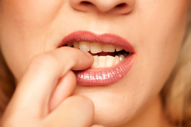 istock Closeup of woman biting her fingernails 1167548912