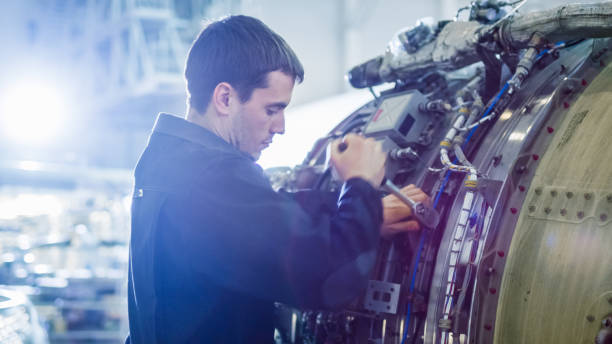 istock Aircraft Maintenance Mechanic Inspecting and Working on Airplane Jet Engine in Hangar 1167549613