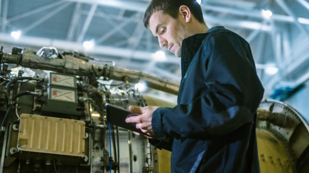 istock Aircraft Maintenance Mechanic Inspecting and Working on Airplane Jet Engine in Hangar 1167549635