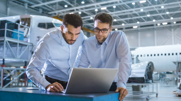 istock Two Aircraft Mechanics Working and Having Conversation next to Laptop Computer 1167549636