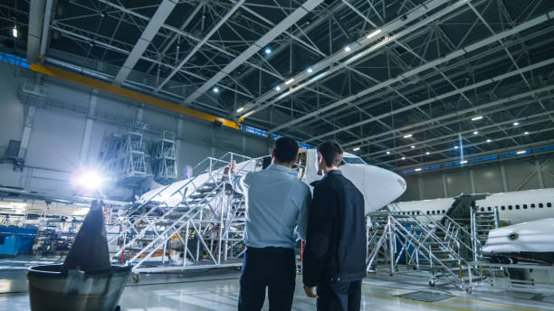 istock Aircraft Maintenance Worker and Engineer Having Conversation. Looking at the airplane. 1167549645