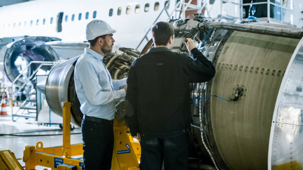 istock Aircraft Maintenance Engineer and Mechanic Inspecting and Working on Airplane Jet Engine in Hangar 1167549649